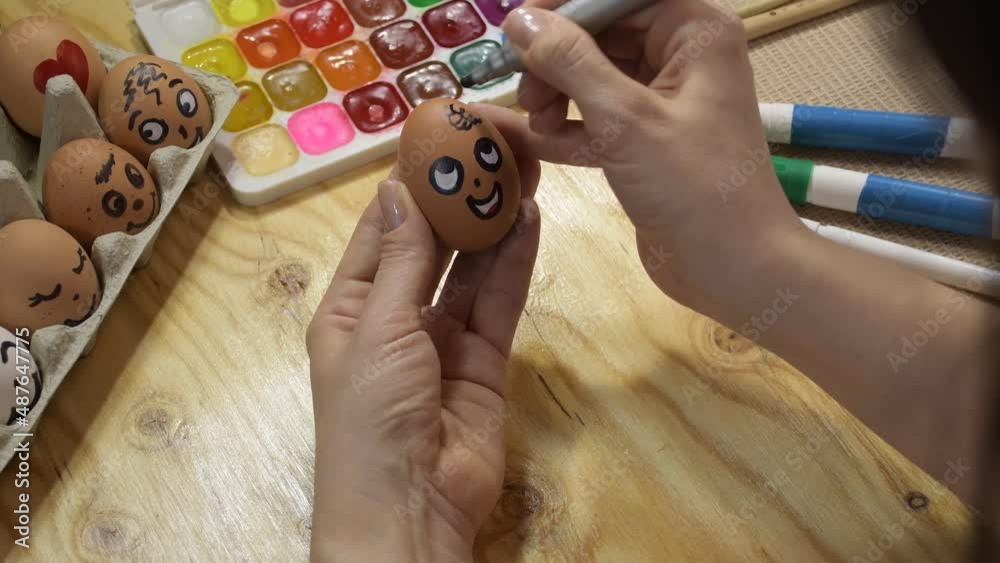Easter decoration painted eggs with the image of a face. Drawing a face