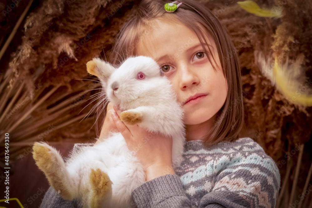 Happy young beautiful girl with little rabbit. Easter portrait. Horizontal image.