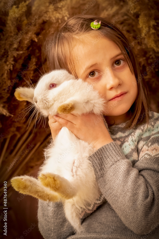 Young beautiful girl with little rabbit. Easter portrait. Close up. Vertical image. Young beautiful girl with little rabbit. Easter portrait. Close up. Vertical image.