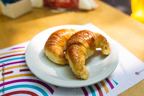 croissant on plate on wooden table