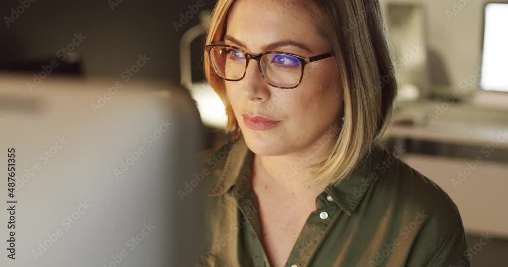 Focused on making success happen. 4k video of a young businesswoman working late on a computer in an office. Focused on making success happen. 4k video of a young businesswoman working late on a computer in an office.