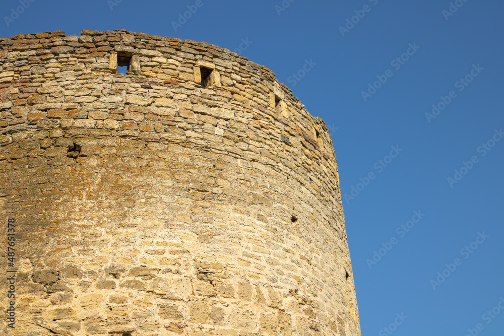 Holes for medieval guns in a defensive fortress. Space for protection in stone walls. The point of warfare in the citadels. Details of architecture. Holes for medieval guns in a defensive fortress. Space for protection in stone walls. The point of warfare in the citadels. Details of architecture.