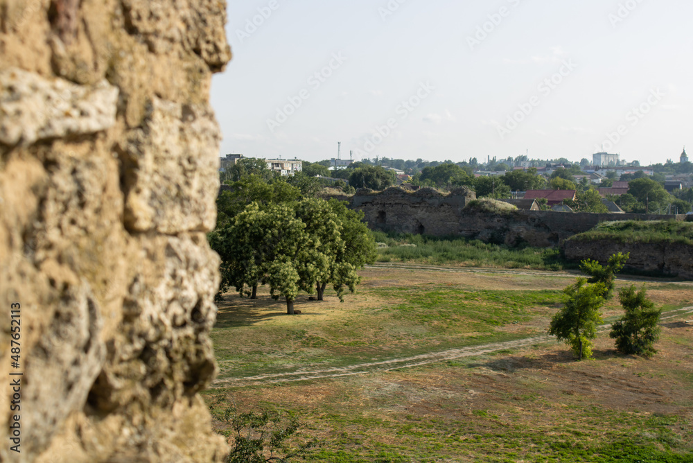 Fototapeta premium Ancient citadel fortress. Military tower fortifications. Medieval security defensive wall surrounding the old town. Archaeological excavations ruins bastion Ackerman.