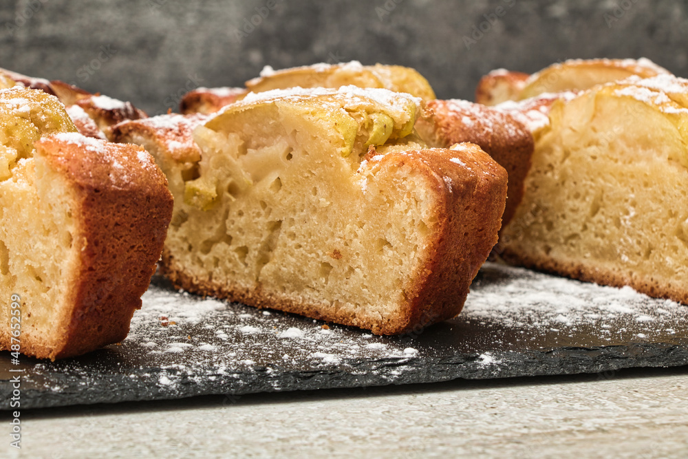 Apple cake made from fresh apples sprinkled with powdered sugar