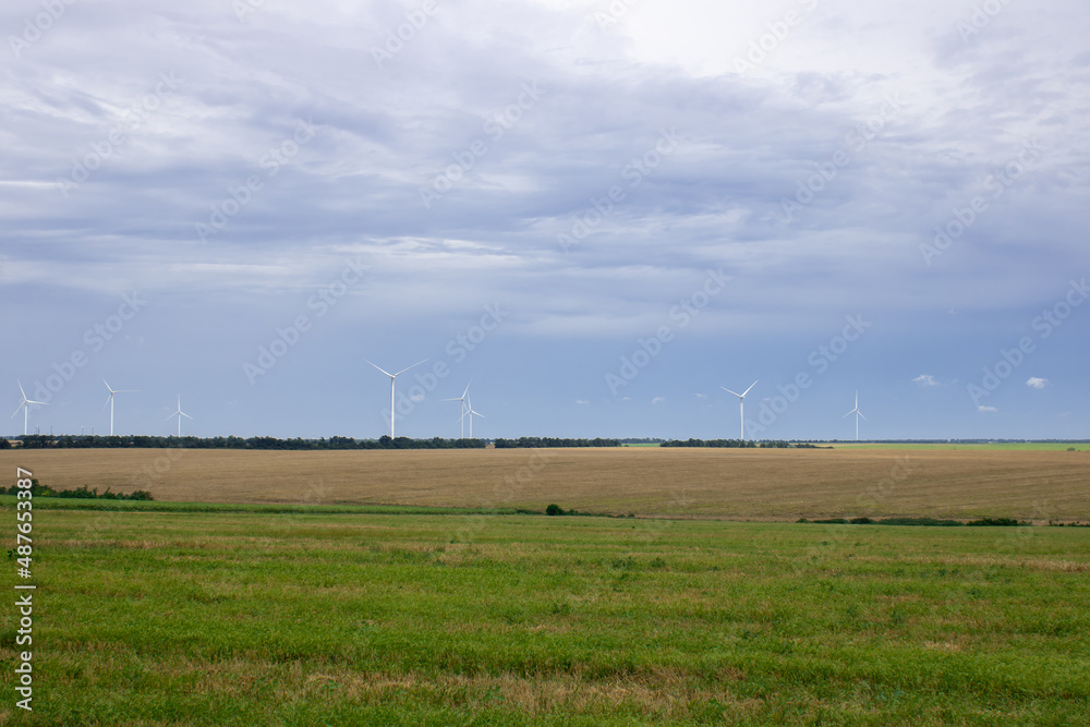Windpower and agriculture. Wind turbines for electricity generation. Windmill renewable energy farm. Eco-energy of nature. Windpower and agriculture. Wind turbines for electricity generation. Windmill renewable energy farm. Eco-energy of nature.