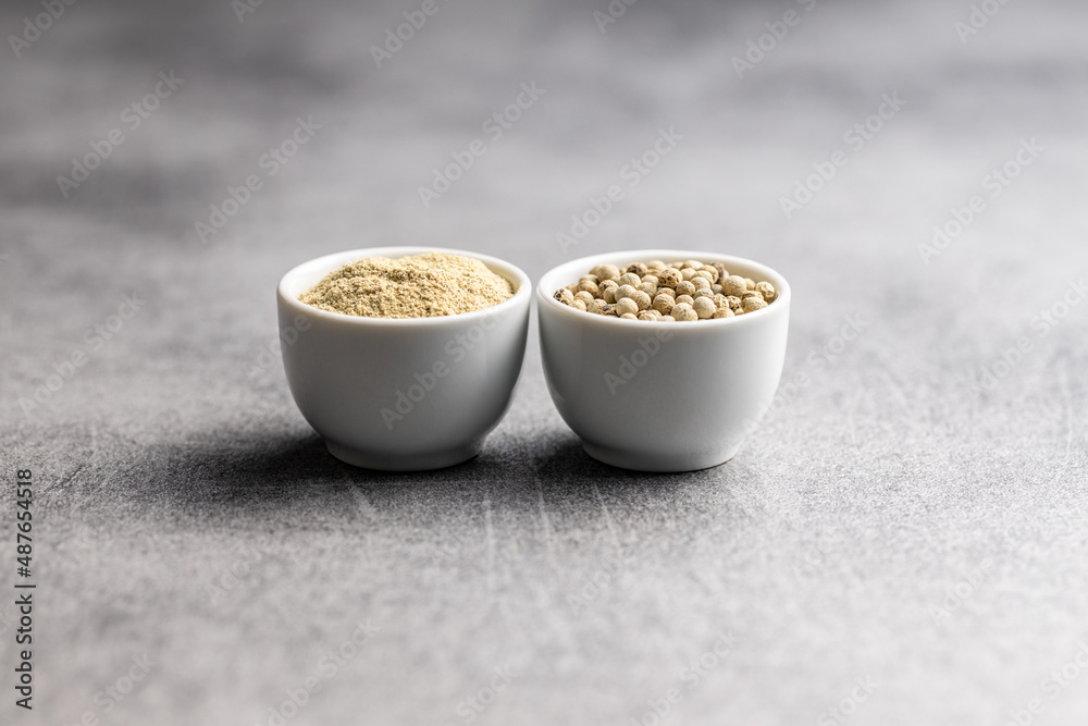 White ground pepper and whole peppercorn spice in bowl. White ground pepper and whole peppercorn spice in bowl.