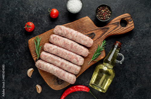 raw sausages on stone background