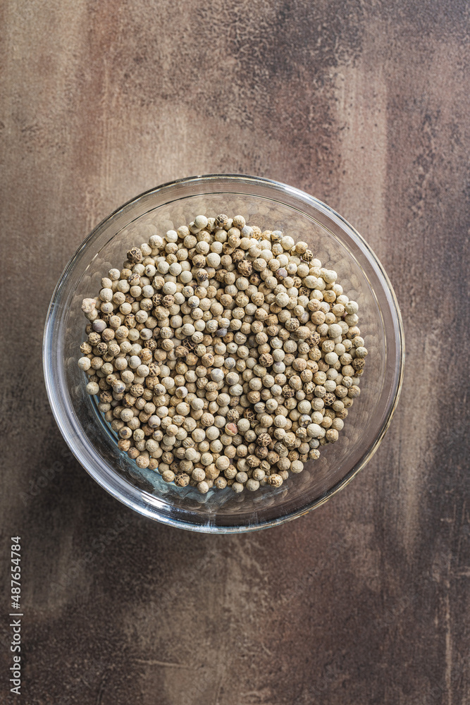 Whole pepper spice. White peppercorn in bowl. Top view. Whole pepper spice. White peppercorn in bowl. Top view.