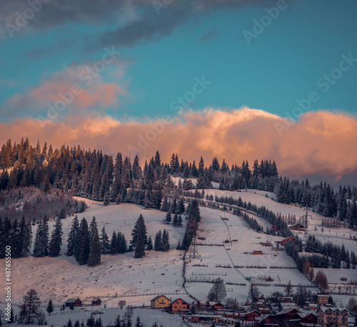 Amazing sunrise. Winter forest. High mountains with snow white peaks.  Location place Carpathian, Vatra Dornei, Bucovina, Suceava, Romania, Europe. photo