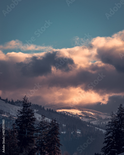 Amazing sunrise. Winter forest. High mountains with snow white peaks. Location place Carpathian, Vatra Dornei, Bucovina, Suceava, Romania, Europe.