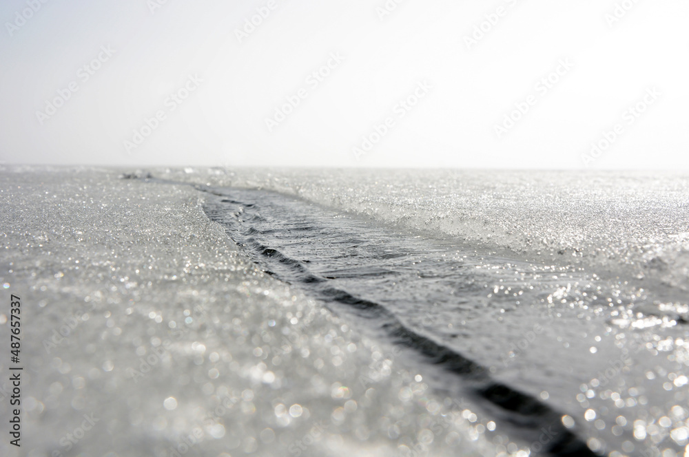 A dangerous crack in the ice of the frozen Gulf of Finland in winter. Russia, Saint-Petersburg A dangerous crack in the ice of the frozen Gulf of Finland in winter. Russia, Saint-Petersburg