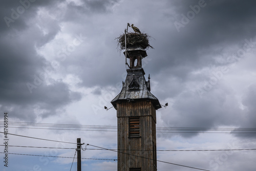 Nest of white storks on a wooden tower in Miedzyrzecze Gorne village in Silesia region, Poland