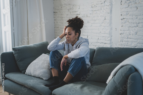 Lonely african american young woman suffering from depression, stress and mental health disorders