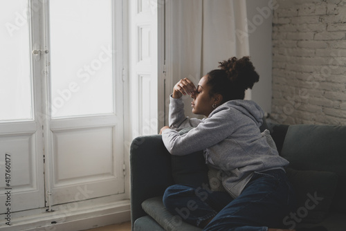 Lonely african american young woman suffering from depression, stress and mental health disorders