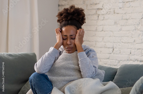 Sad black woman suffering from depression symptoms feeling distressed alone at home