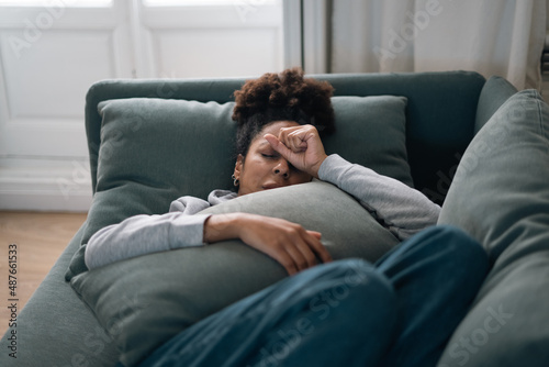Sad black woman suffering from depression symptoms feeling distressed alone at home