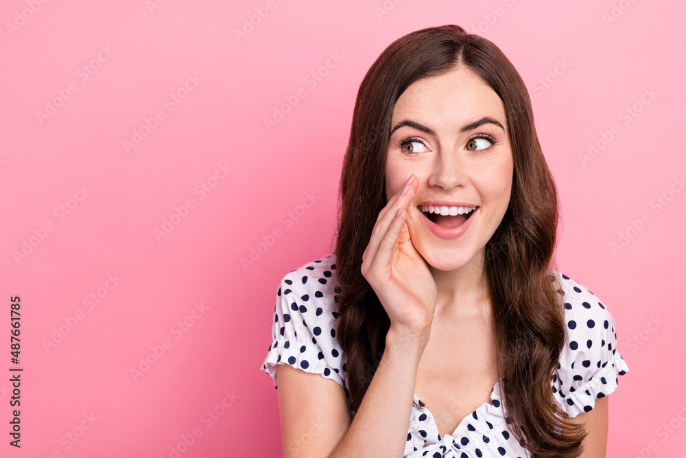 Photo of funny funky lady dressed dotted dress arm lips telling secret looking empty space isolated pink color background Photo of funny funky lady dressed dotted dress arm lips telling secret looking empty space isolated pink color background