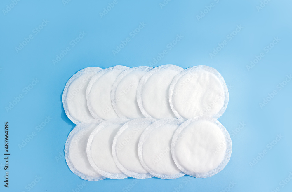 Absorbent breast pads on blue background. Concept of natural breastfeeding. Copy space Absorbent breast pads on blue background. Concept of natural breastfeeding. Copy space