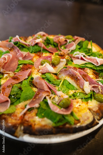 raw ham pizza and rucula