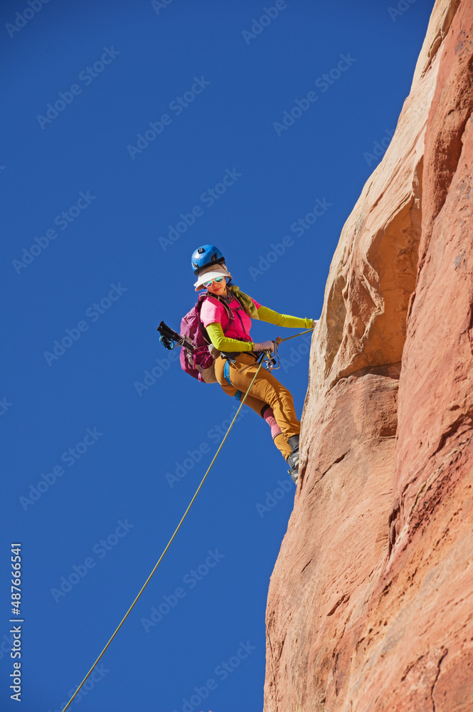 Woman Rappelling Sandstone Cliff
