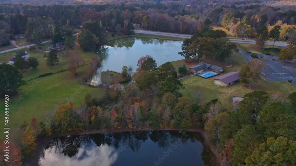 Drone Landscape over fall lake facing pretty fall lake with street in background Drone Landscape over fall lake facing pretty fall lake with street in background