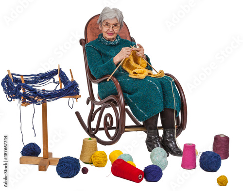 Old woman knitting, against a white background