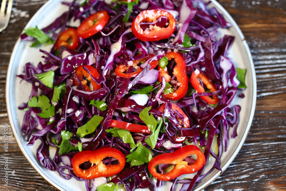 Healthy blue cabbage salad on a plate. Vegan food. Diet.