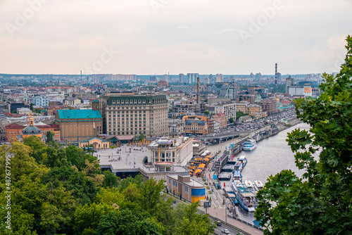 Kyiv, Ukraine. July 20, 2021. Aerial view of kiev cityscape with cruise port at dnieper river and traffic jam with of cars on highway motorway