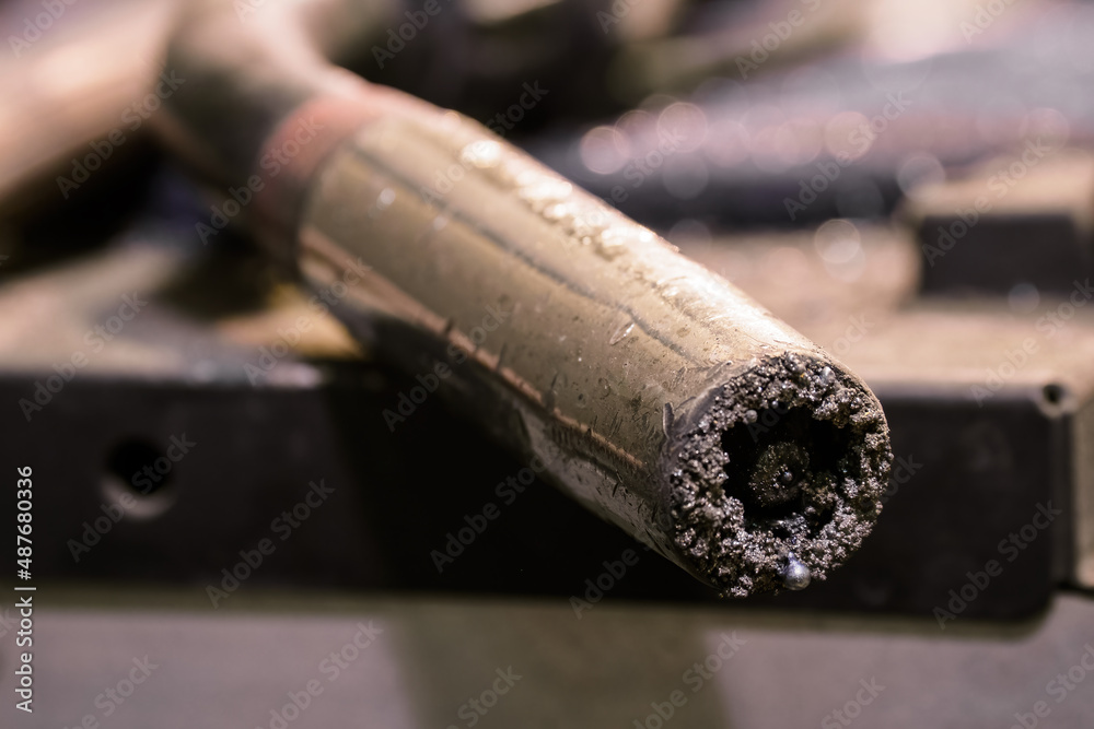 Detail of a clogged welding nozzle with a feed wire. Detail of a clogged welding nozzle with a feed wire.