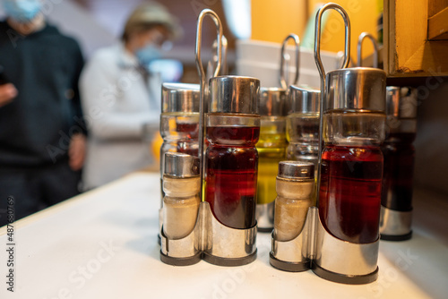 Oil and vinegar containers on top of a bar table