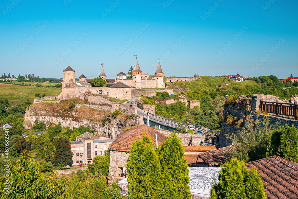 View of the ancient Kamianets Podilskyi Castle with townscape of buildings and trees. Beautiful view of castle.