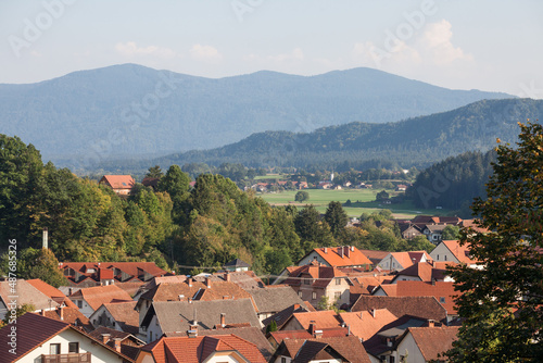 Aerial panorama of Ljubno ob Savinji, a typical central europea village of Slovenia, with individual houses, farmhouses, buildings and fields in a rural agricultural environment... photo
