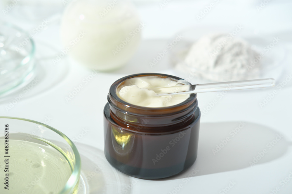 petri dishes with medium and glassware on a laboratory table. fermentation, fermented beauty skin care. container with cream or solution or serum for anti age treatment developed in a lab petri dishes with medium and glassware on a laboratory table. fermentation, fermented beauty skin care. container with cream or solution or serum for anti age treatment developed in a lab