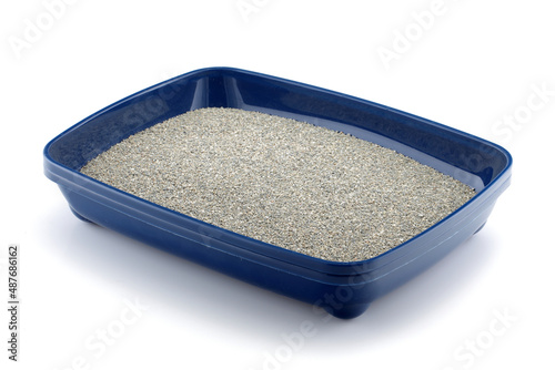 A blue cat litter tray with clumping litter isolated on white