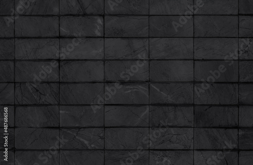 Black tiles ceramic wall and floor, dark marble abstract background. Design geometric mosaic texture decoration 
