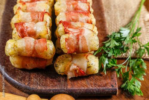 Cassava skewers wrapped in bacon, cassava medallion.