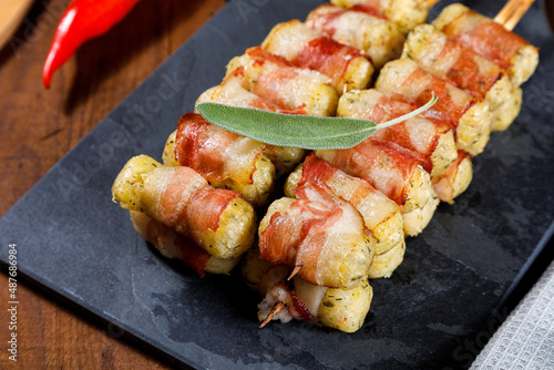 Cassava skewers wrapped in bacon, cassava medallion.