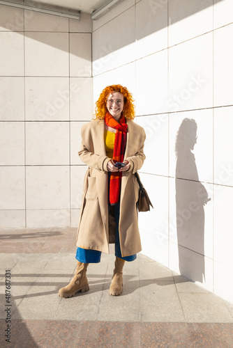 Ginger woman dressed in casual modern clothes smiling