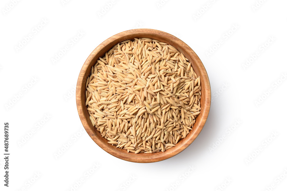 Flat lay (top view) of paddy jasmine rice in wooden bowl isolated on white background. Clipping path. Flat lay (top view) of paddy jasmine rice in wooden bowl isolated on white background. Clipping path.