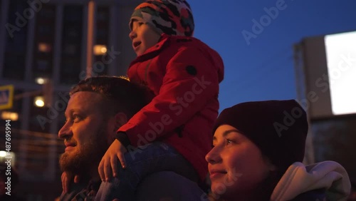 Happy family look at the sky at the fireworks.
