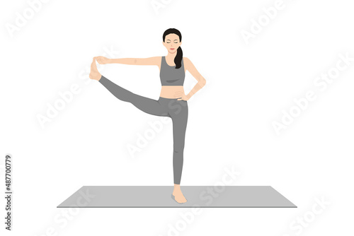 Standing Hand to Big Toe Pose. Beautiful girl practice Utthita Hasta Padangusthasana. Young attractive woman practicing yoga exercise. working out, black wearing sportswear, grey pants and top, indoor