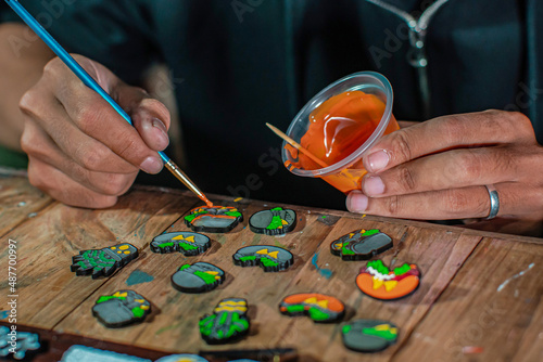 Craft pins made of acrylic and colored using enamel paint, all done manually in a home workshop photo