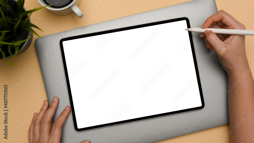 A female hands using a stylus pen draw on digital tablet A female hands using a stylus pen draw on digital tablet