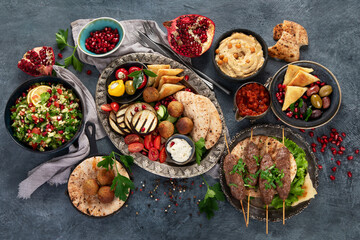 Arabic food assortment on dark background.