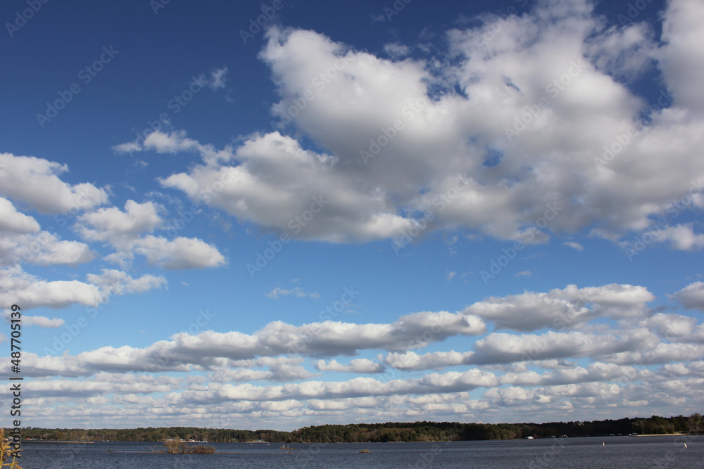 Obraz premium Lake Tyler near Whitehouse TX with Blue Sky and Fluffy Clouds