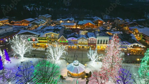Cinematic 4K aerial drone night pan shot of decorated Front St in Leavenworth, a Bavarian-styled tourist destination village in the Cascade Mountains, in Washington State photo