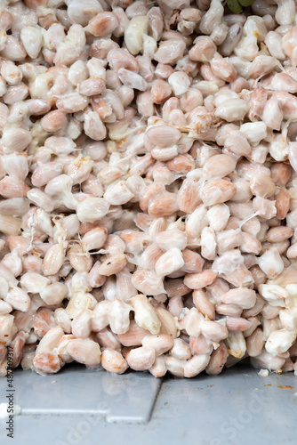 Cocoa beans and cocoa pod on a wooden surface.