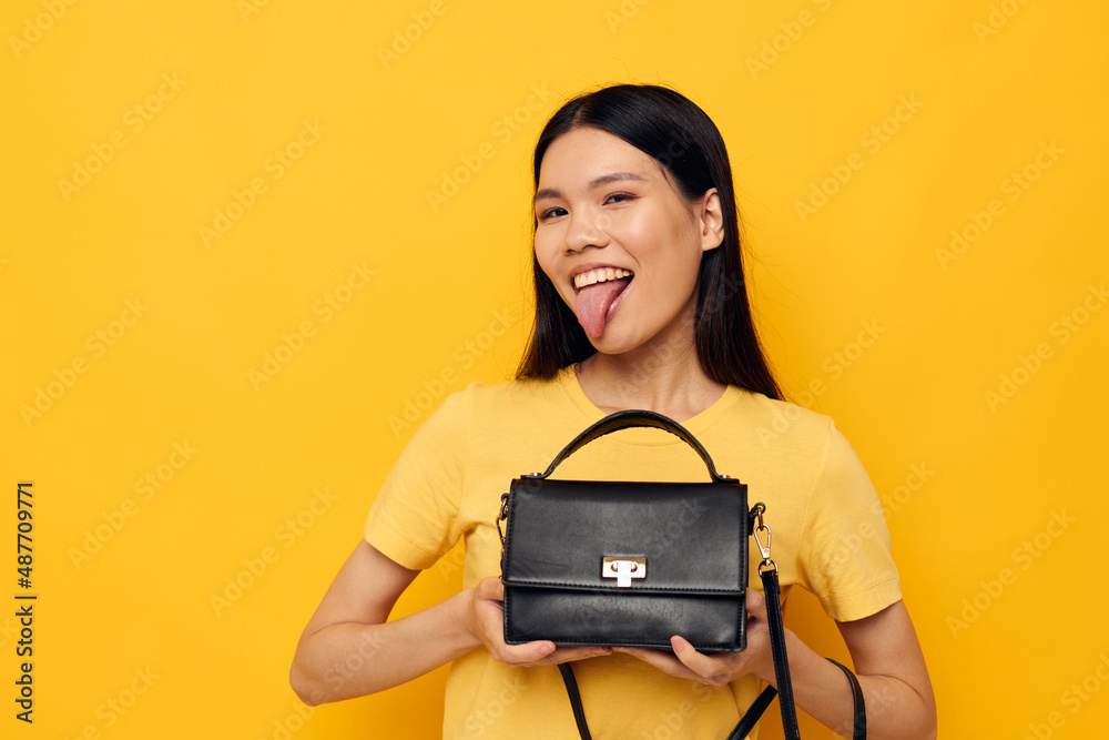 woman with Asian appearance female clutch accessories posing studio model unaltered woman with Asian appearance female clutch accessories posing studio model unaltered