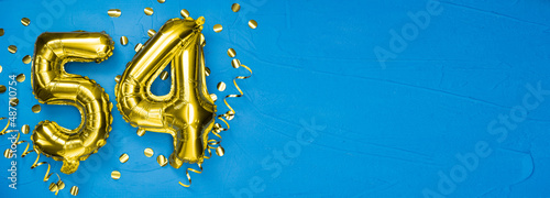 golden foil balloon number fifty four. Birthday or anniversary card with the inscription 54. blue concrete background. Anniversary celebration. Banner. photo