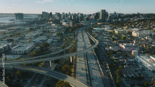 Cinematic aerial downtown San Diego busy highway to modern buildings at sunset photo
